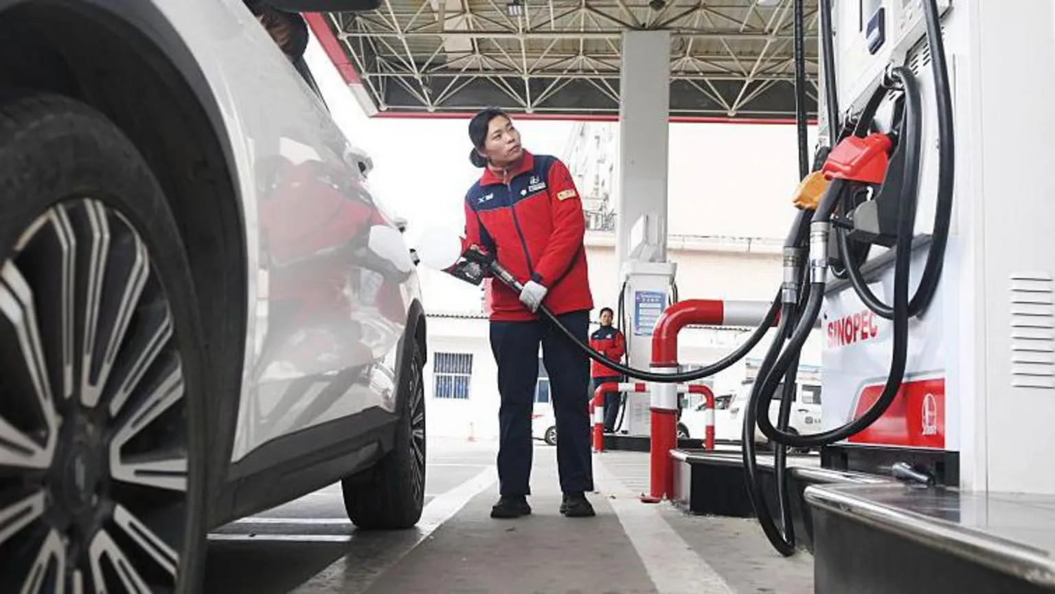 China halves planned fuel price increases amid global oil supply fears