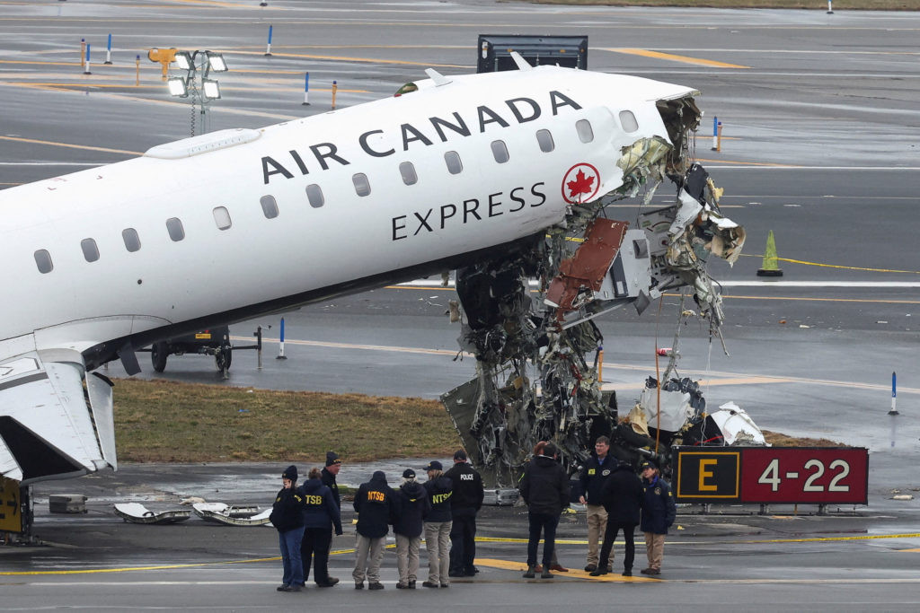 Deadly collision between Air Canada jet and fire truck at LaGuardia kills two pilots